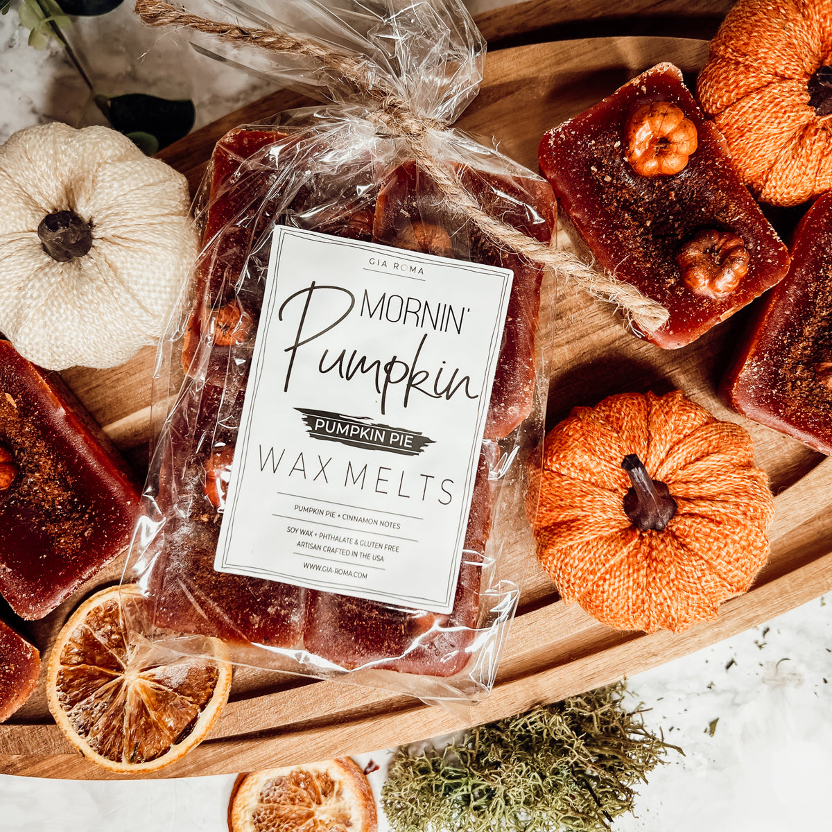 A close-up of Pumpkin Buttercream wax melts, showcasing their rich color and texture, with a hint of spices visible on the surface.