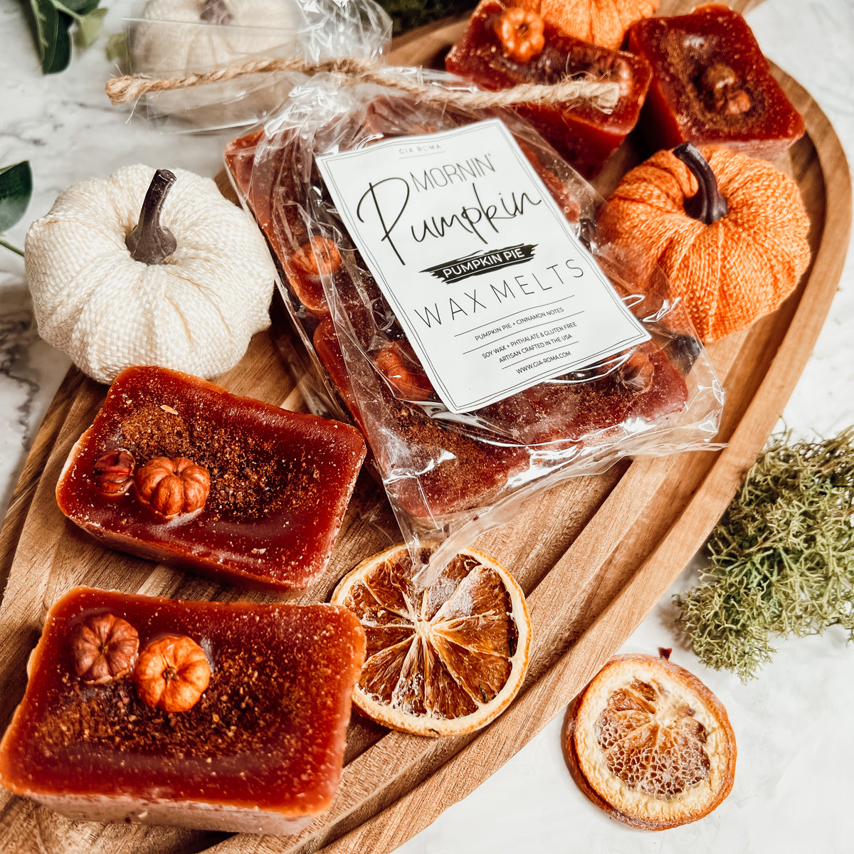 A close-up of Pumpkin Buttercream wax melts, showcasing their rich color and texture, with a hint of spices visible on the surface.