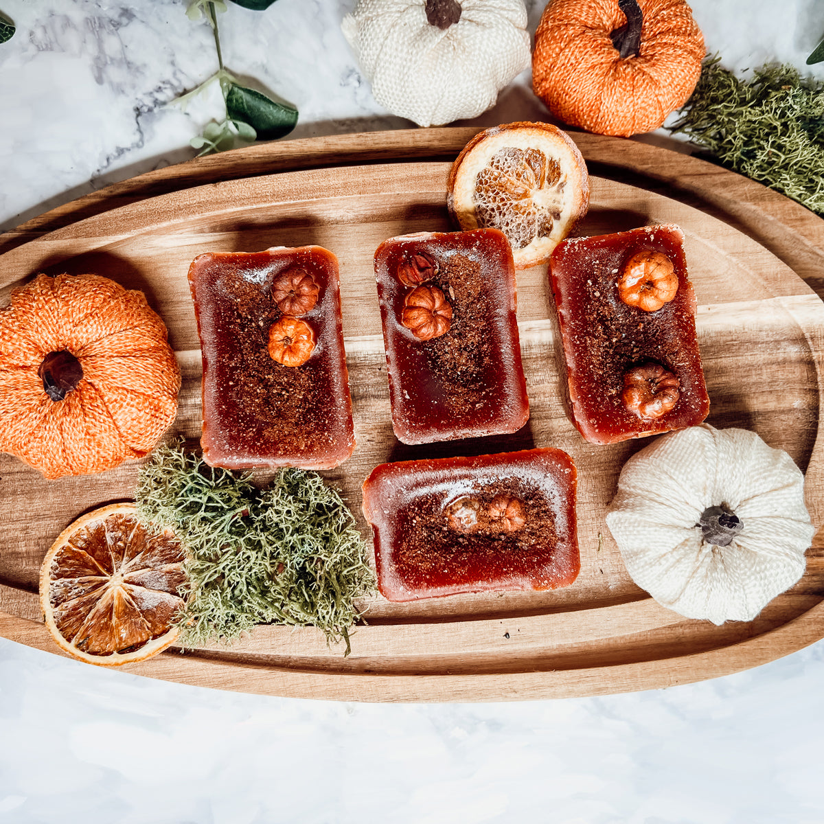 A close-up of Pumpkin Buttercream wax melts, showcasing their rich color and texture, with a hint of spices visible on the surface.