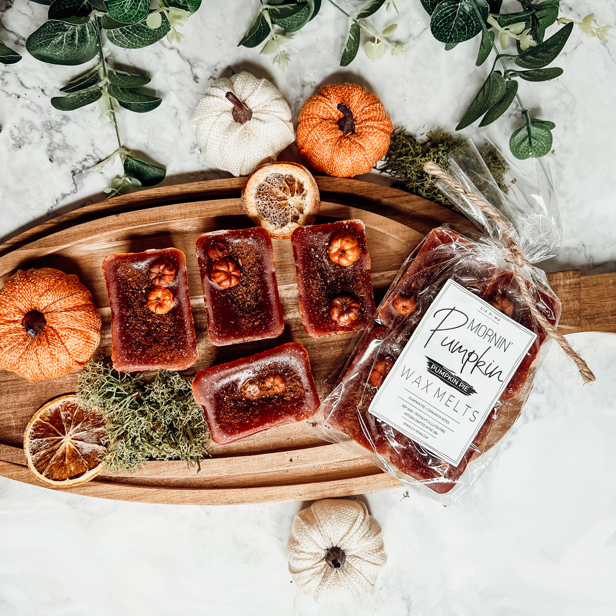 A close-up of Pumpkin Buttercream wax melts, showcasing their rich color and texture, with a hint of spices visible on the surface.