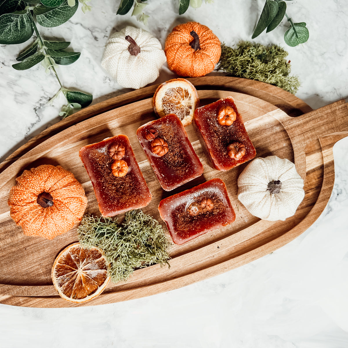 A close-up of Pumpkin Buttercream wax melts, showcasing their rich color and texture, with a hint of spices visible on the surface.