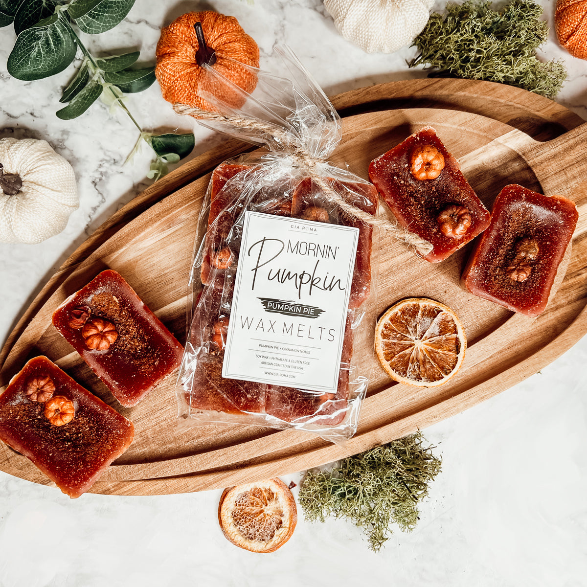 A close-up of Pumpkin Buttercream wax melts, showcasing their rich color and texture, with a hint of spices visible on the surface.