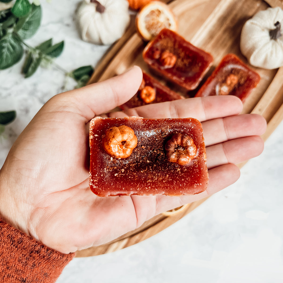 A close-up of Pumpkin Buttercream wax melts, showcasing their rich color and texture, with a hint of spices visible on the surface.