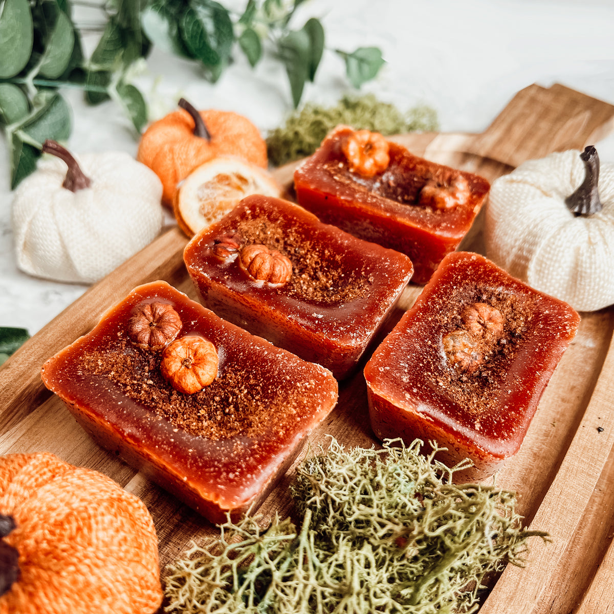 A close-up of Pumpkin Buttercream wax melts, showcasing their rich color and texture, with a hint of spices visible on the surface.