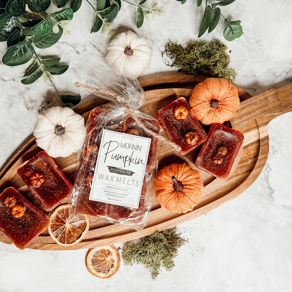 A close-up of Pumpkin Buttercream wax melts, showcasing their rich color and texture, with a hint of spices visible on the surface.