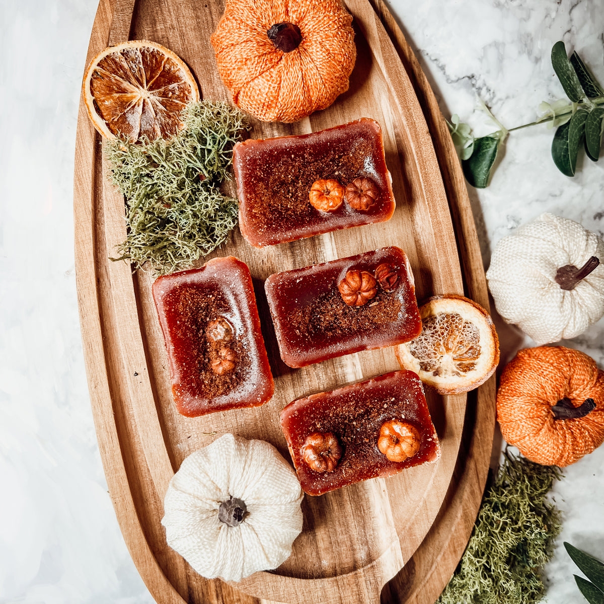 A close-up of Pumpkin Buttercream wax melts, showcasing their rich color and texture, with a hint of spices visible on the surface.