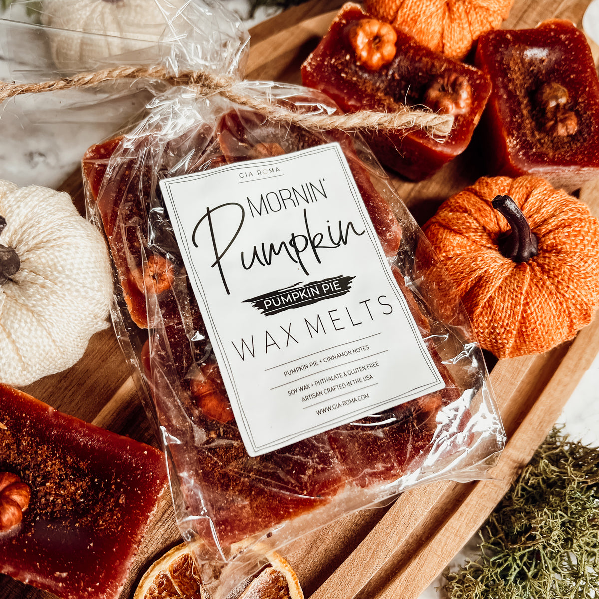 A close-up of Pumpkin Buttercream wax melts, showcasing their rich color and texture, with a hint of spices visible on the surface.