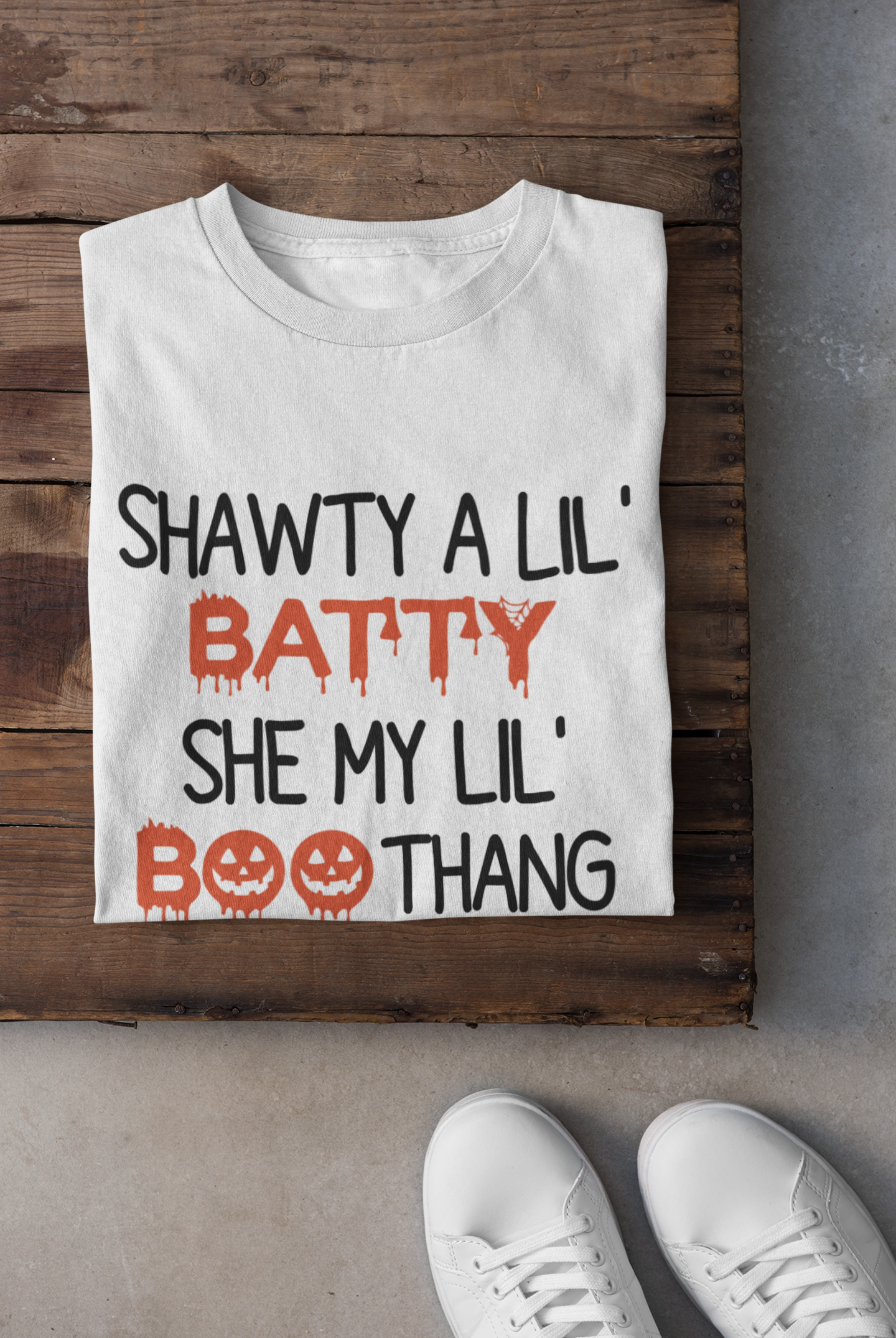 Shawty A Lil' Batty She My Lil' Boo Thang Shirt displayed on a hanger, showcasing its vibrant design and classic fit.