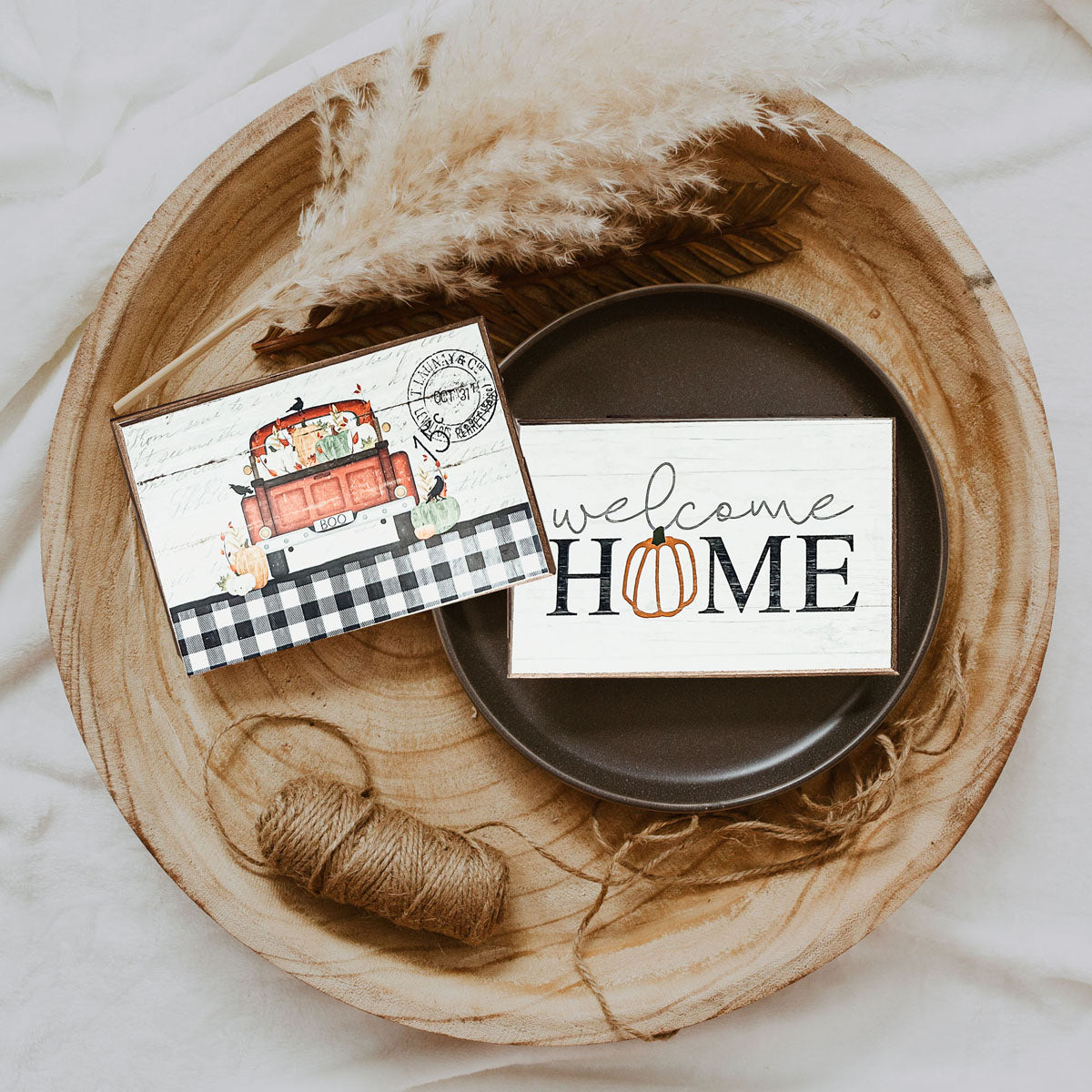 A handmade wooden sign reading 'Welcome Home' with a pumpkin graphic as the 'O', perfect for fall and Halloween decor.