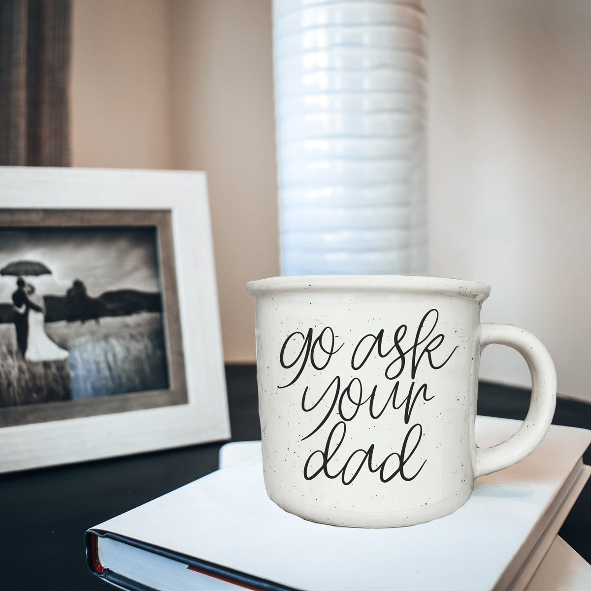 Go Ask Your Dad Ceramic Coffee Mug with light ivory glaze and black lettering, featuring a campfire style design, perfect for busy parents.