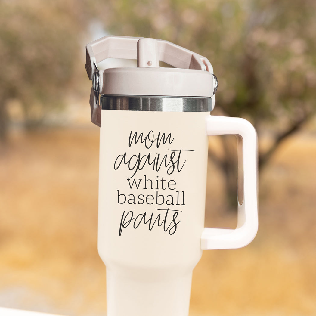 A stylish 40oz tumbler with a cream exterior and stainless steel interior, featuring the bold graphic 'Moms Against White Baseball Pants' on the front, designed for durability and practicality.