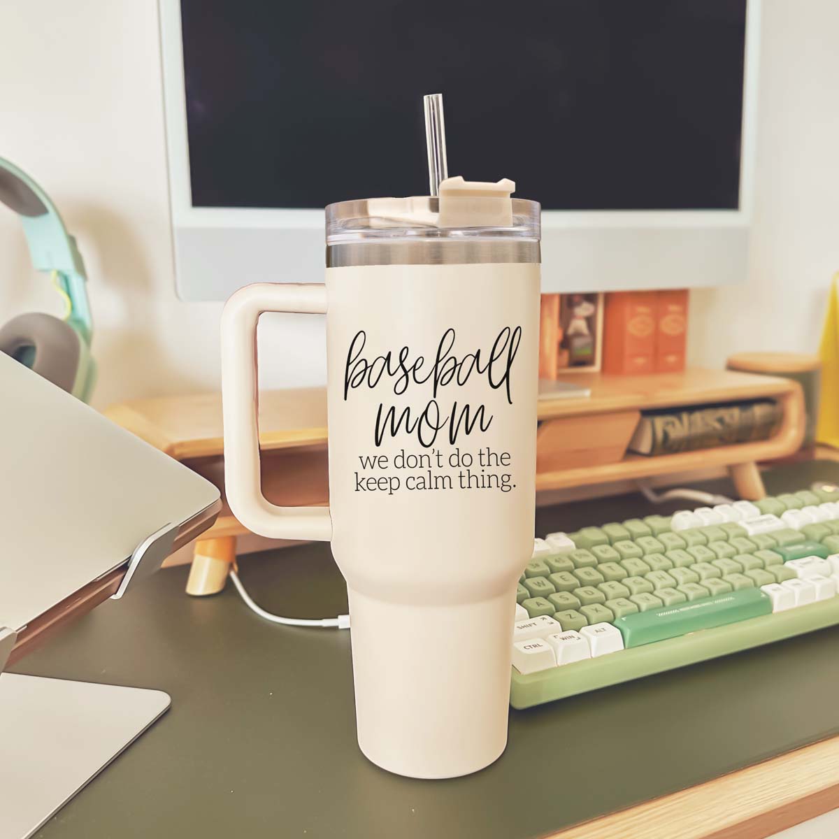 A stylish cream-colored 40oz tumbler with a stainless steel interior, featuring a bold black graphic that reads 'We Don't Do the Keep Calm Thing', designed for baseball moms.