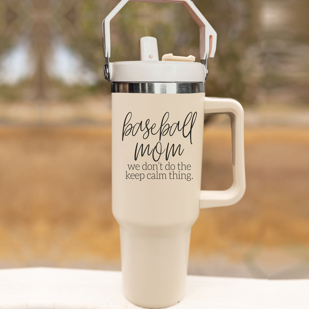 A stylish cream-colored 40oz tumbler with a stainless steel interior, featuring a bold black graphic that reads 'We Don't Do the Keep Calm Thing', designed for baseball moms.