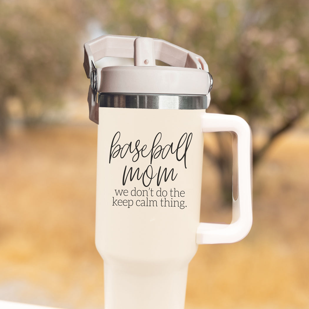 A stylish cream-colored 40oz tumbler with a stainless steel interior, featuring a bold black graphic that reads 'We Don't Do the Keep Calm Thing', designed for baseball moms.