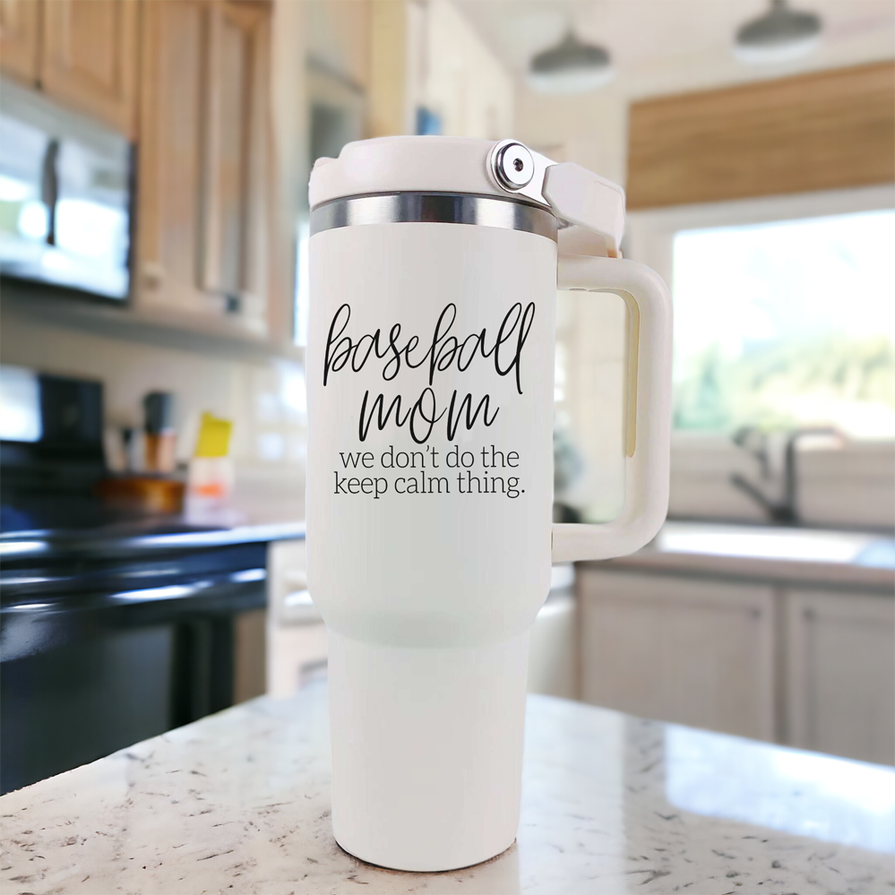 A stylish cream-colored 40oz tumbler with a stainless steel interior, featuring a bold black graphic that reads 'We Don't Do the Keep Calm Thing', designed for baseball moms.