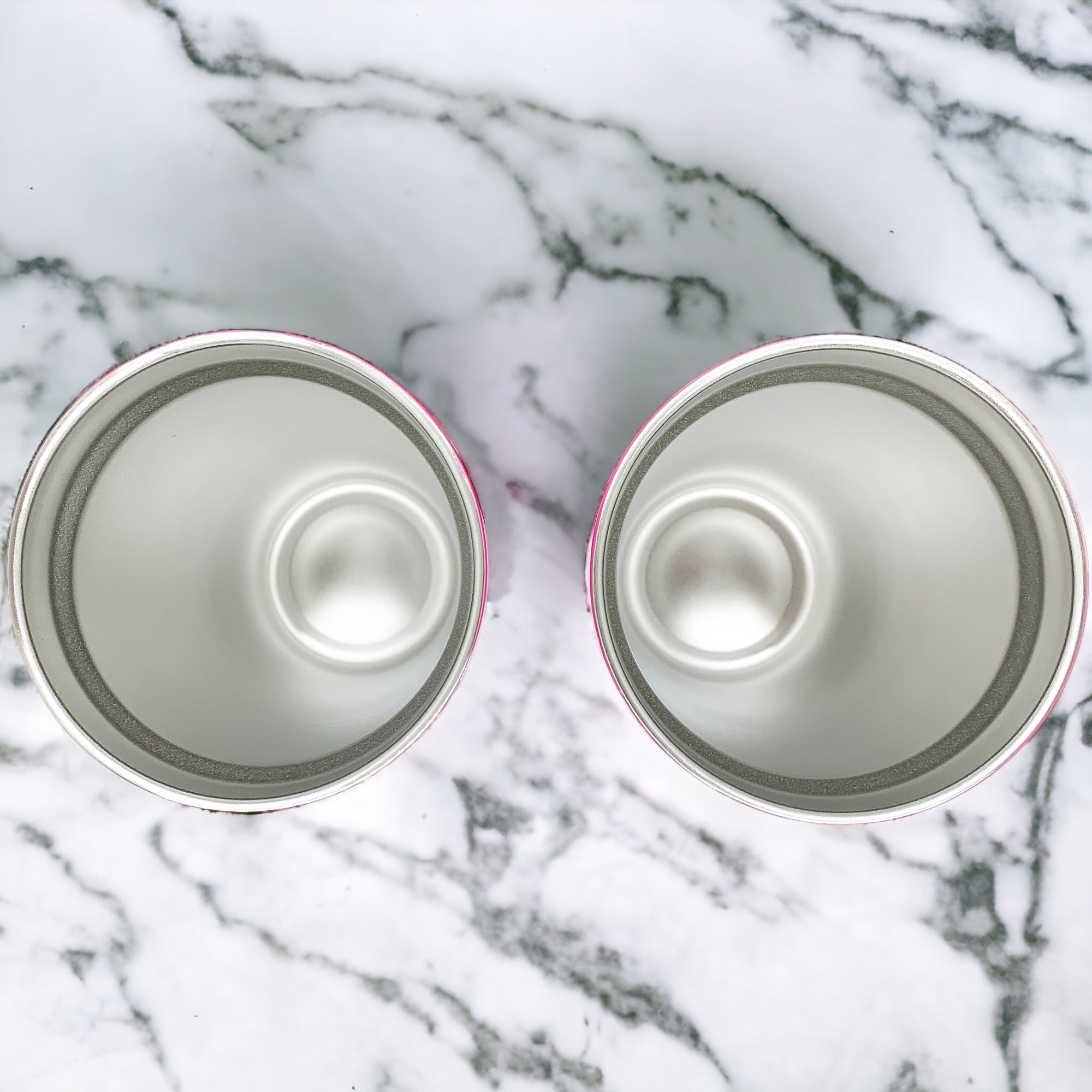 Empty cans on marble surface.