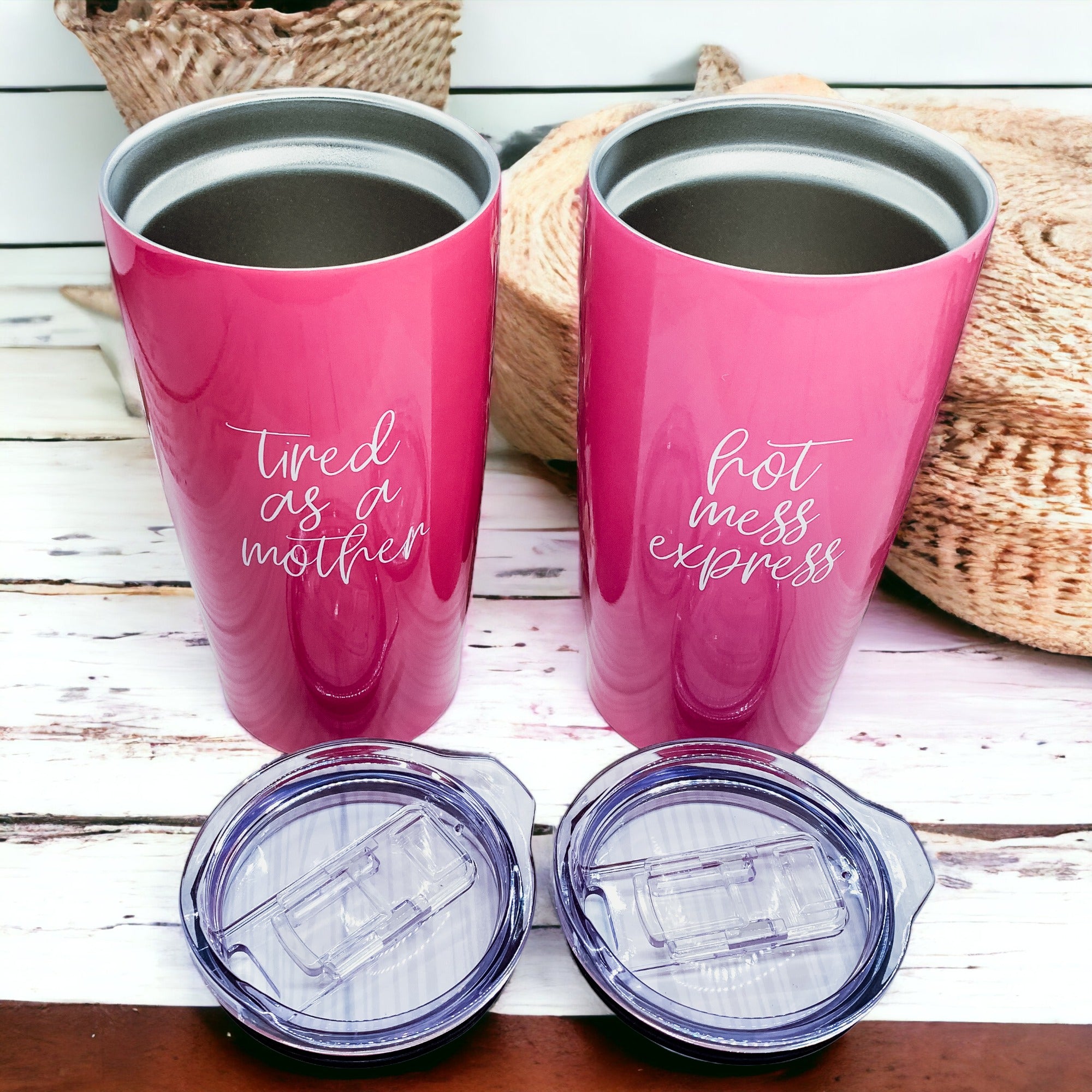 Two pink tumblers with lids.