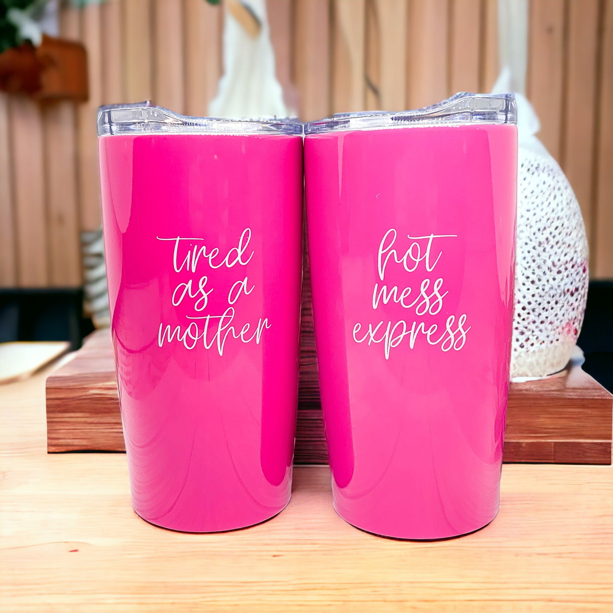 Two pink tumblers with quotes.