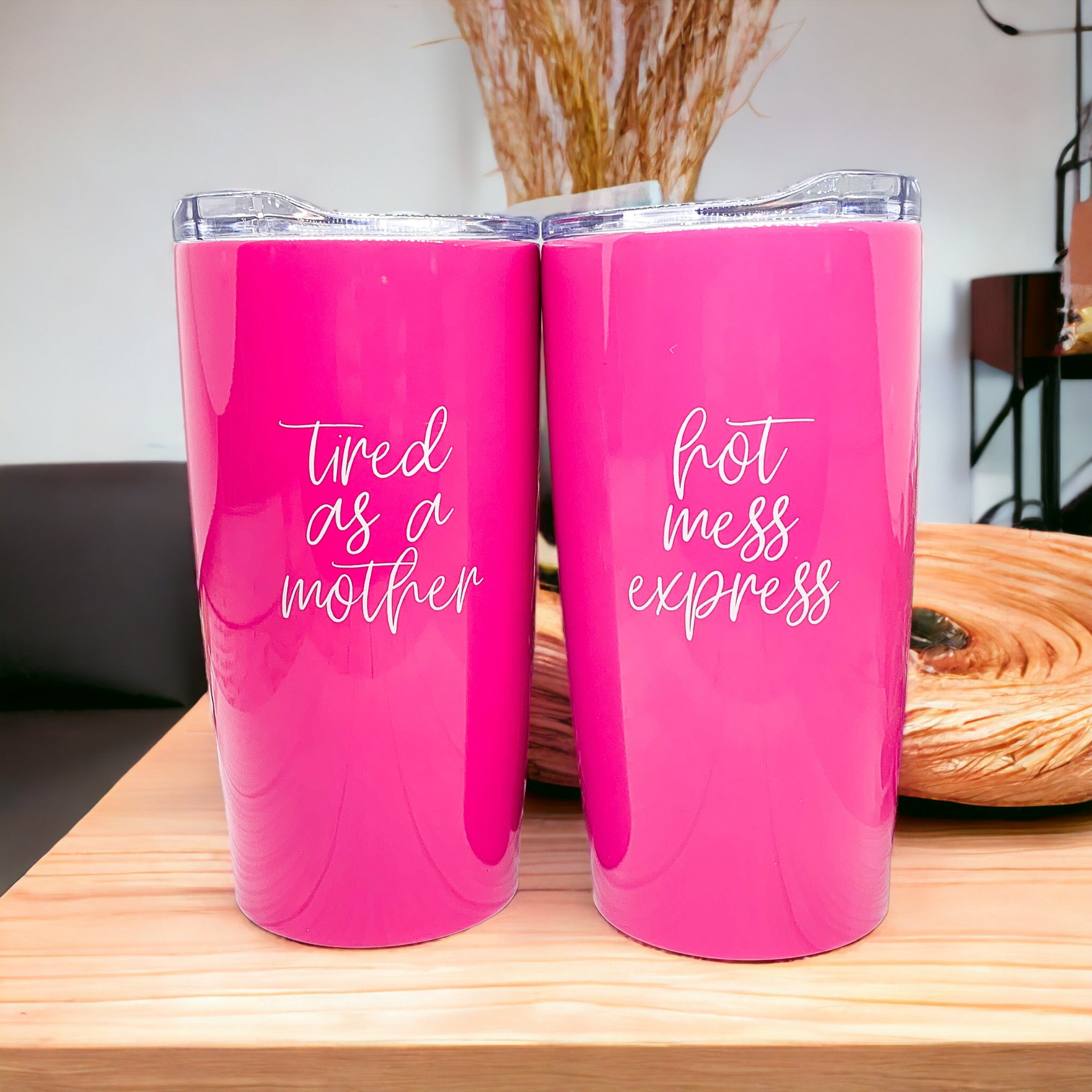 Pink tumblers with humorous quotes.