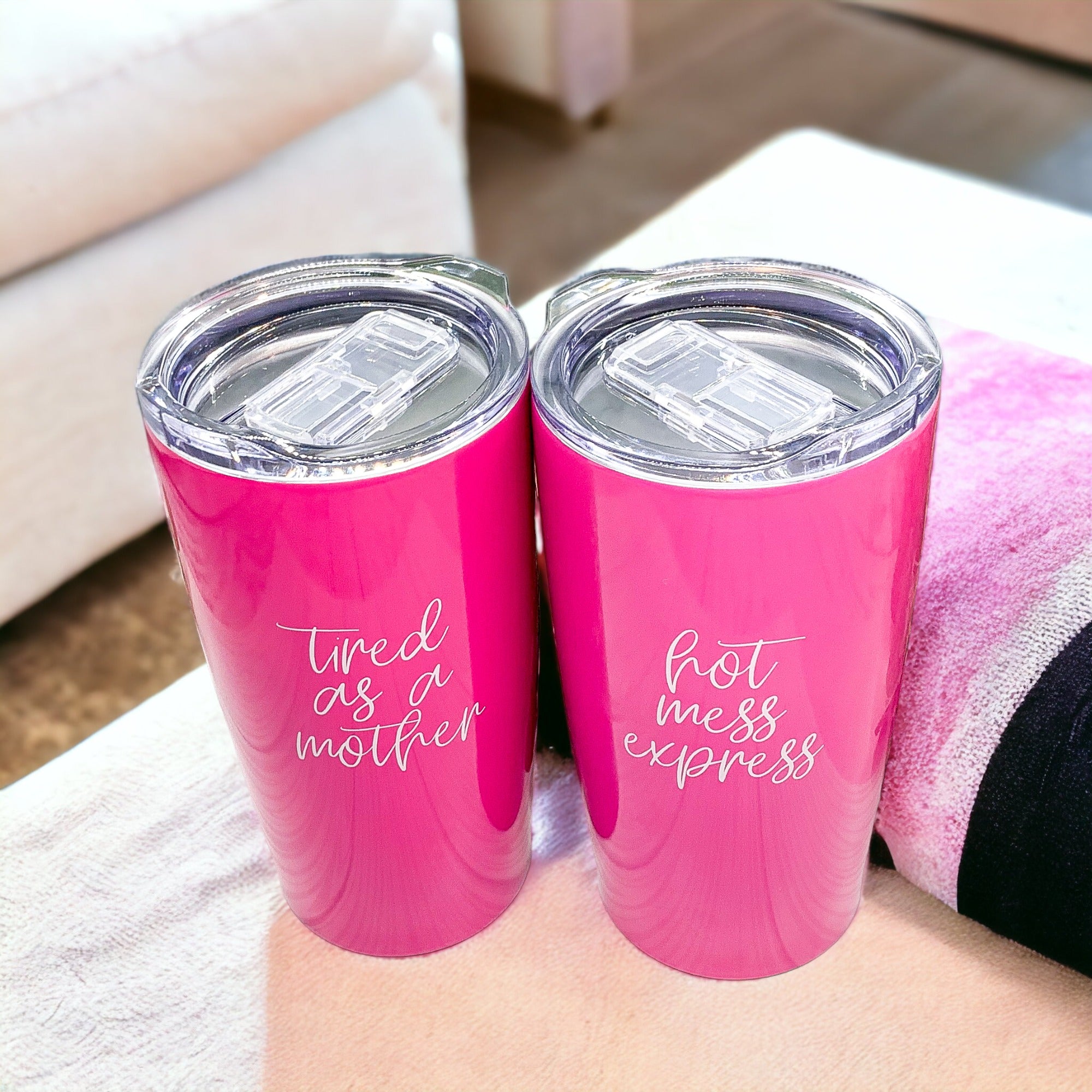 Two pink travel tumblers.