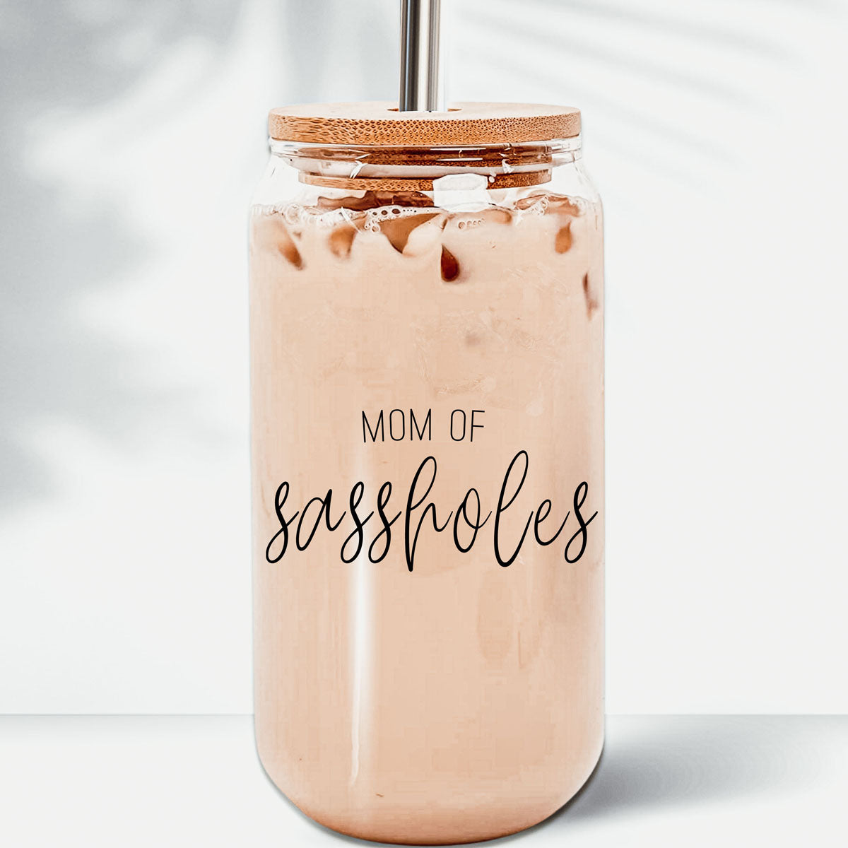 Mom of Sassholes Set featuring stylish glass cups with bamboo lids, stainless steel straws, and a straw cleaner, perfect for sassy moms.