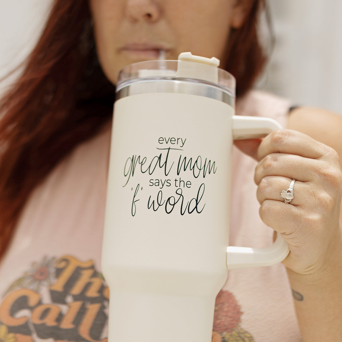 Mom Says the F Word 40oz insulated mug with a matte cream finish, featuring a black graphic design, a removable 3-in-1 lid, and a plastic straw.