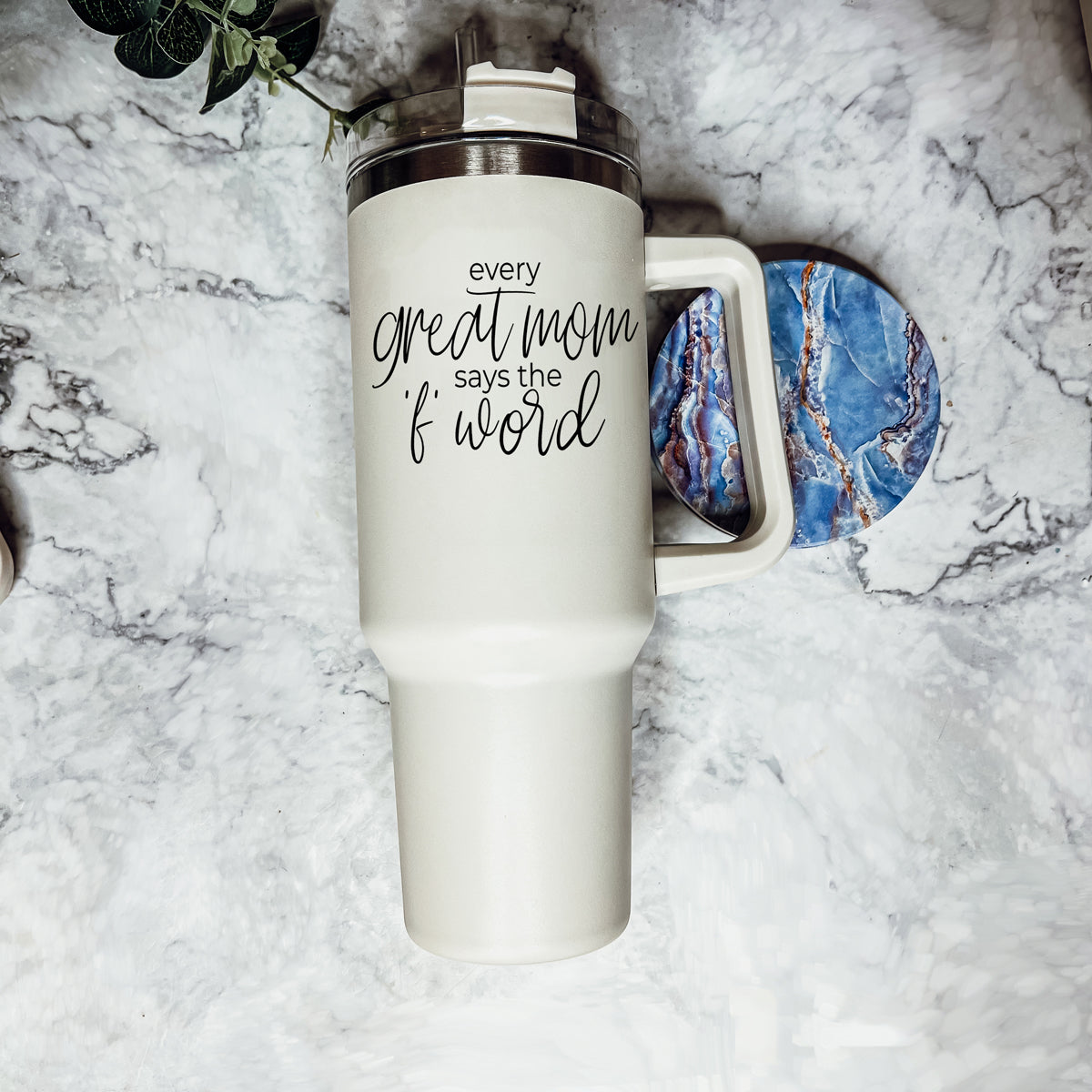 Mom Says the F Word 40oz insulated mug with a matte cream finish, featuring a black graphic design, a removable 3-in-1 lid, and a plastic straw.