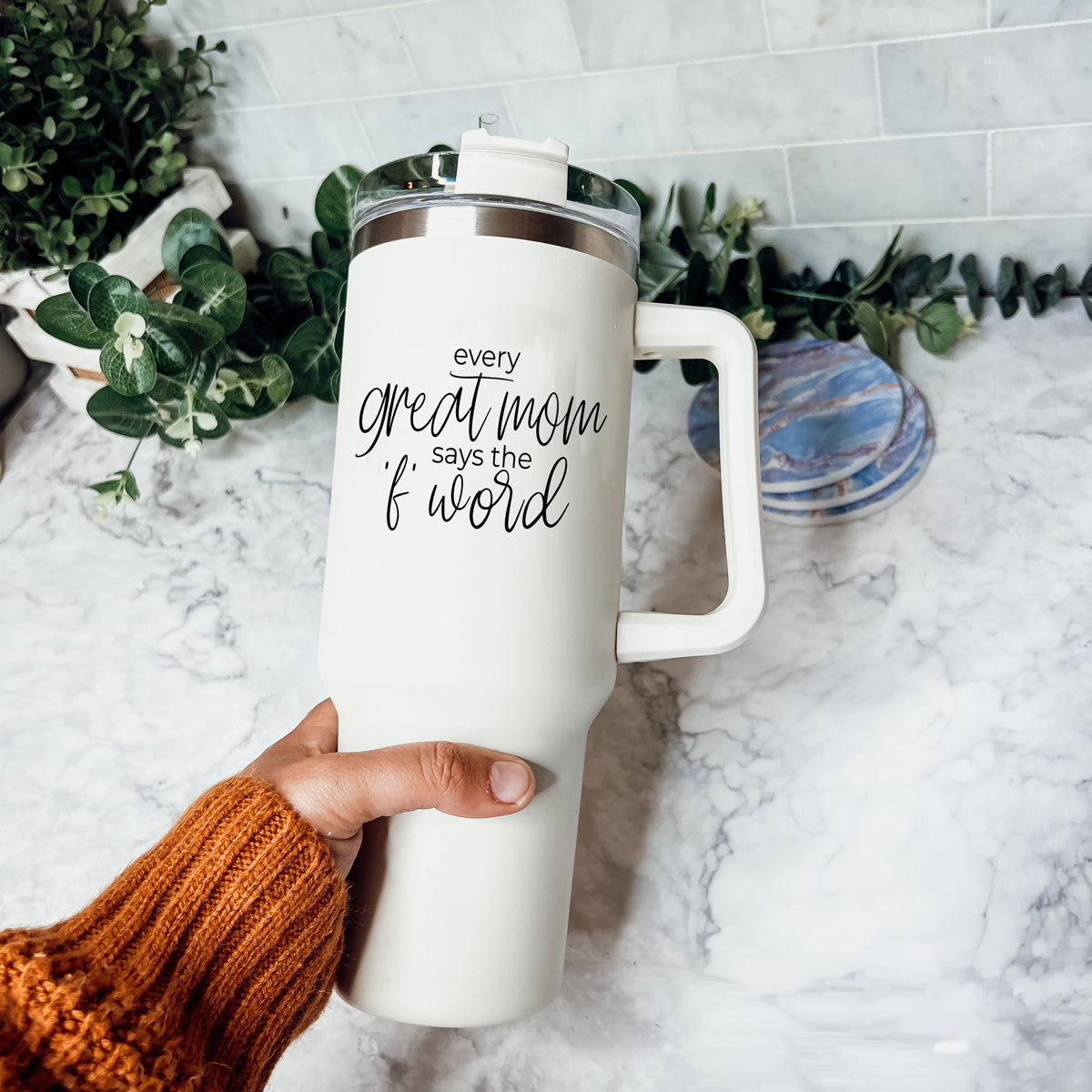 Mom Says the F Word 40oz insulated mug with a matte cream finish, featuring a black graphic design, a removable 3-in-1 lid, and a plastic straw.