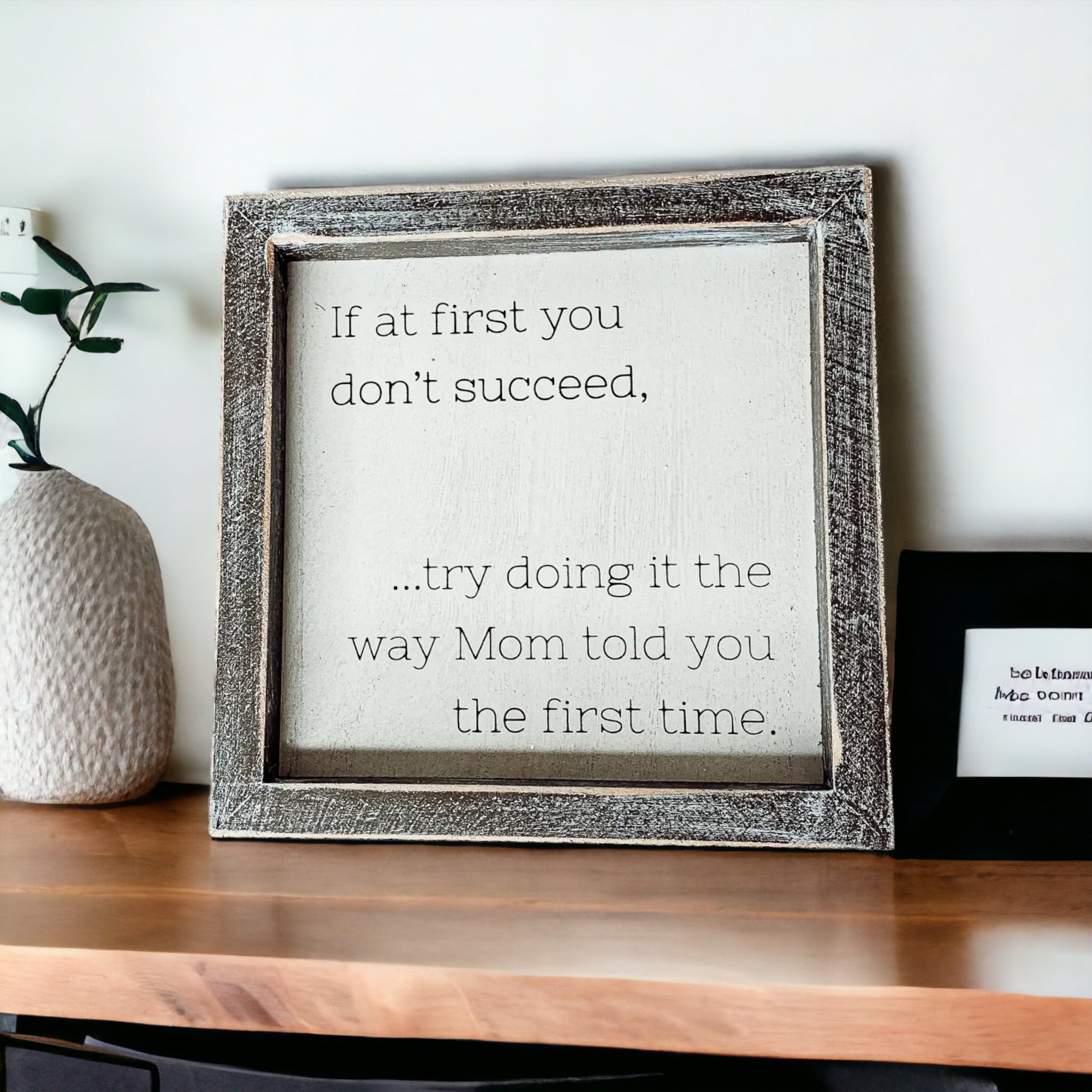 Motivational framed quote on shelf