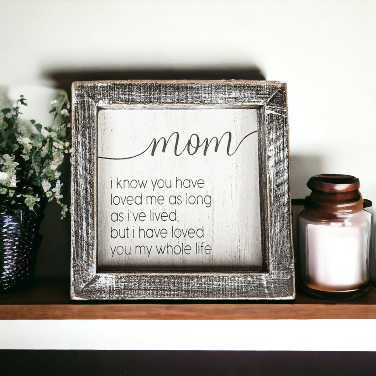 A rustic wooden framed sign measuring 5x5 inches with a heartfelt quote for mothers, perfect for home decor.