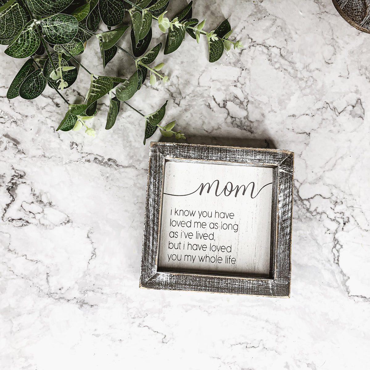 A rustic wooden framed sign measuring 5x5 inches with a heartfelt quote for mothers, perfect for home decor.