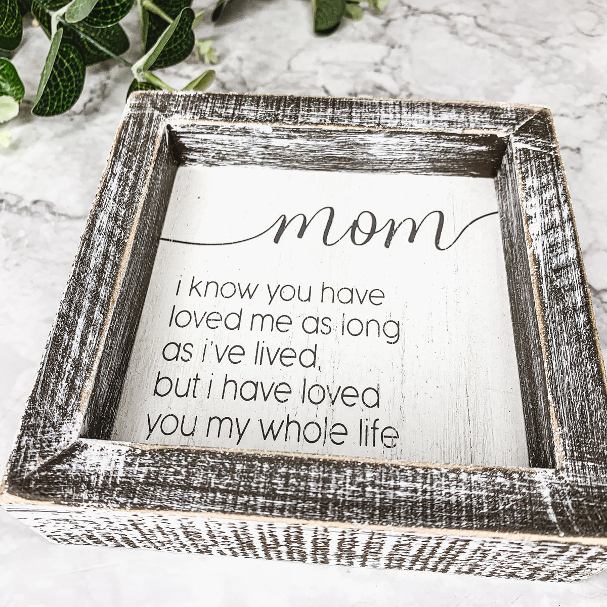 A rustic wooden framed sign measuring 5x5 inches with a heartfelt quote for mothers, perfect for home decor.