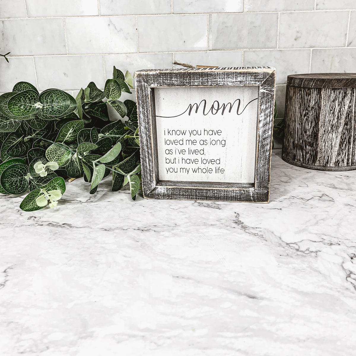 A rustic wooden framed sign measuring 5x5 inches with a heartfelt quote for mothers, perfect for home decor.