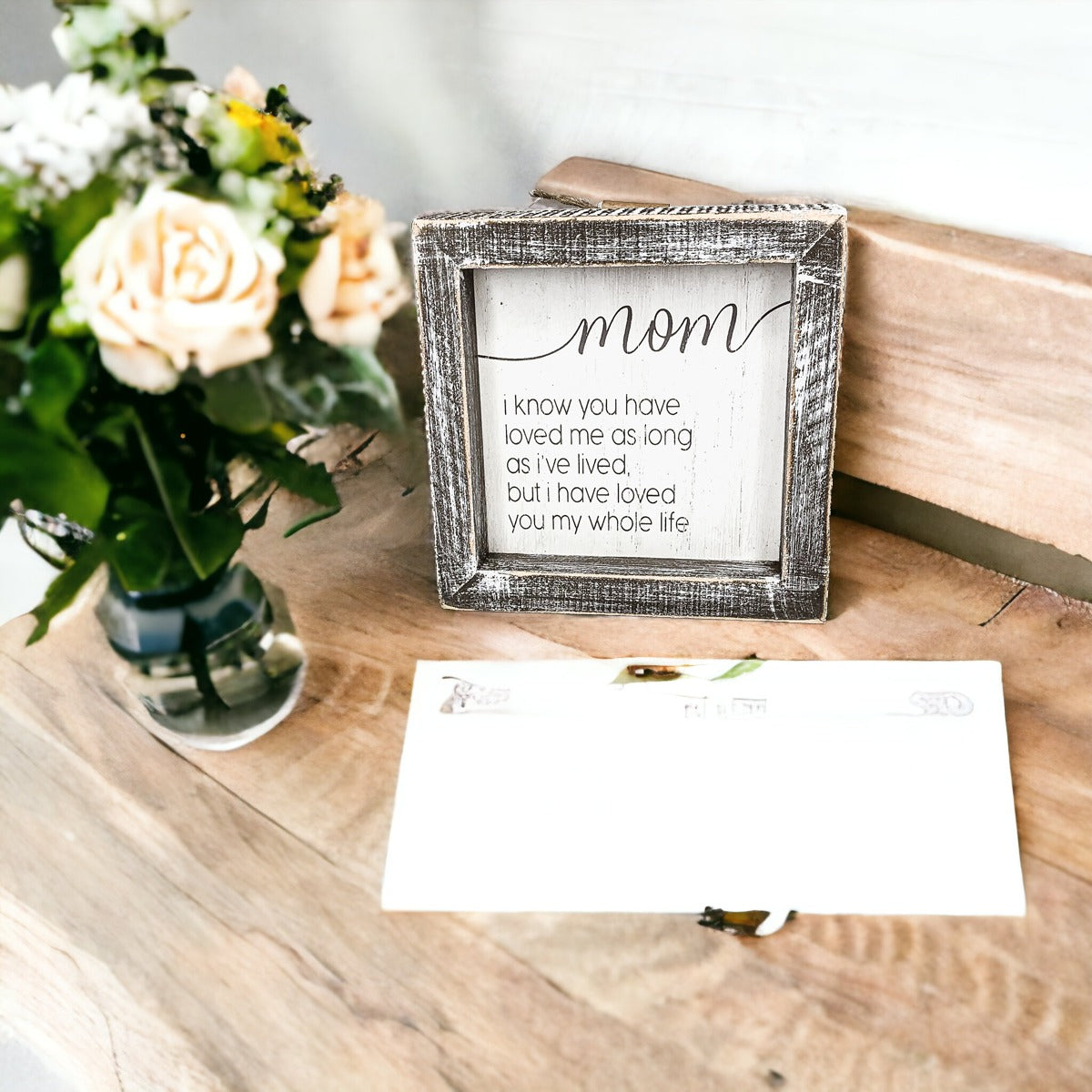 A rustic wooden framed sign measuring 5x5 inches with a heartfelt quote for mothers, perfect for home decor.