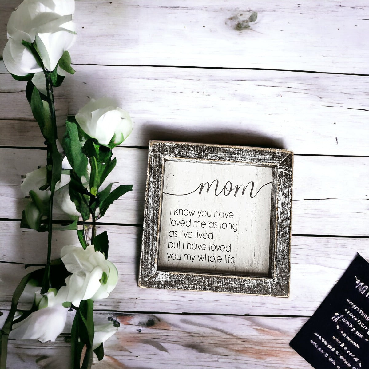 A rustic wooden framed sign measuring 5x5 inches with a heartfelt quote for mothers, perfect for home decor.