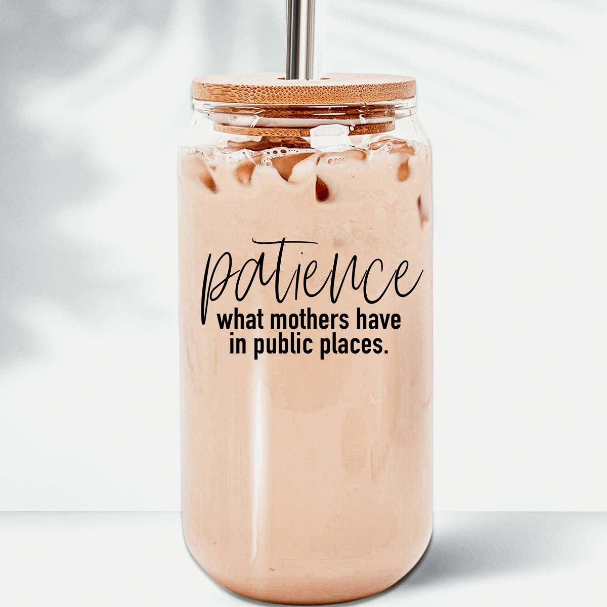 Patience in Public Set featuring a glass cup with bamboo lid, stainless steel straws, and a straw cleaner, showcasing its elegant design and functionality.