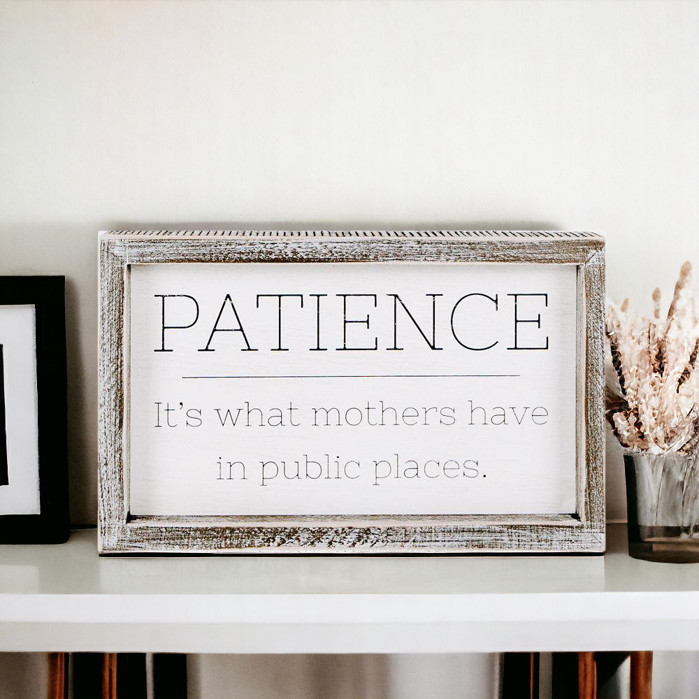 Wooden framed sign with the phrase 'Patience, It's What Mothers Have In Public Places', measuring 10" x 6" x 1.5", suitable for hanging or freestanding display.