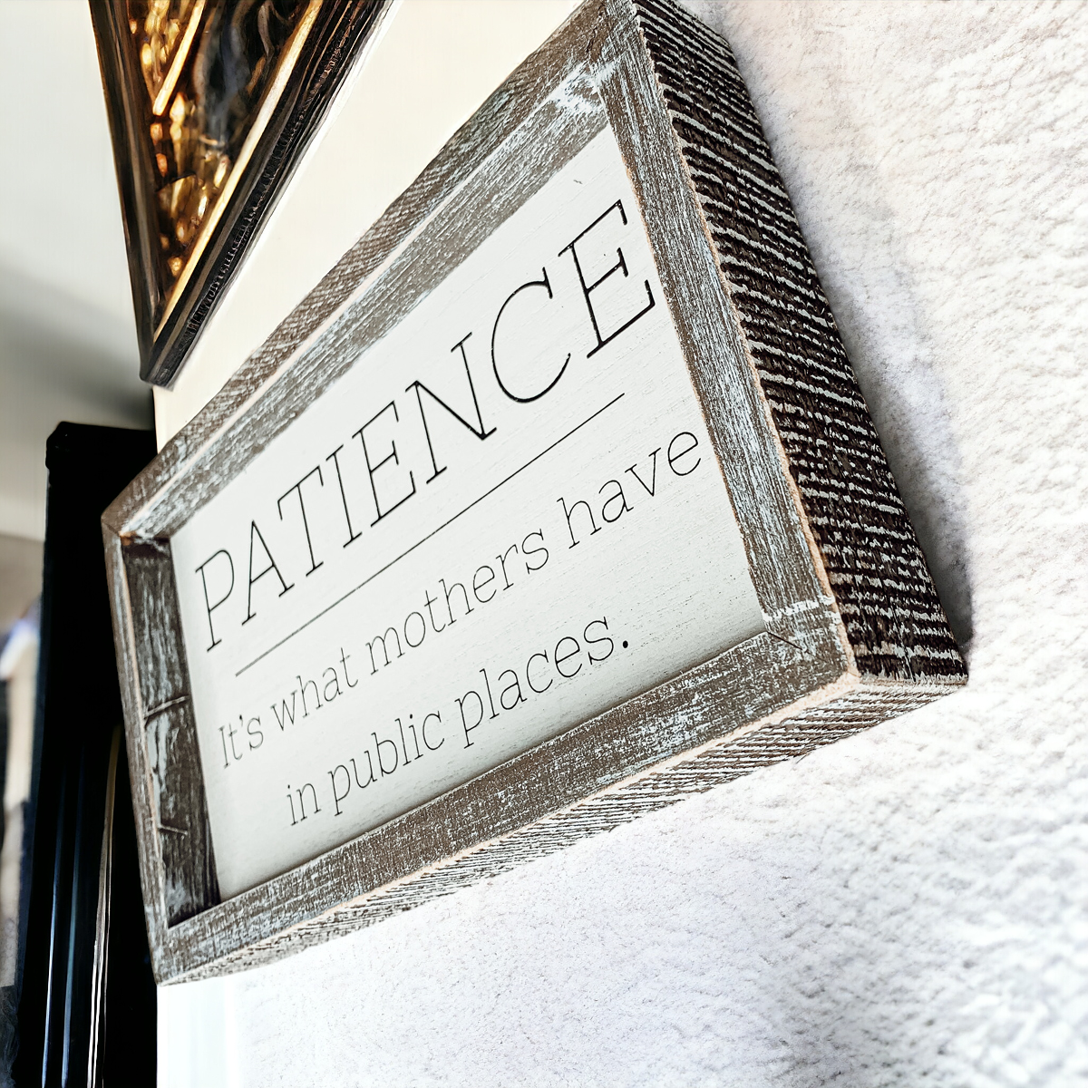 Wooden framed sign with the phrase 'Patience, It's What Mothers Have In Public Places', measuring 10" x 6" x 1.5", suitable for hanging or freestanding display.