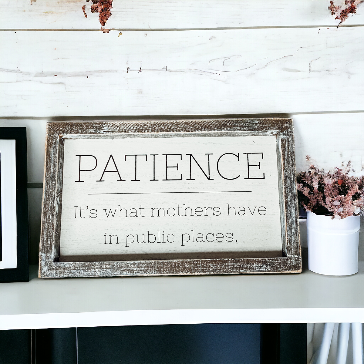 Wooden framed sign with the phrase 'Patience, It's What Mothers Have In Public Places', measuring 10" x 6" x 1.5", suitable for hanging or freestanding display.