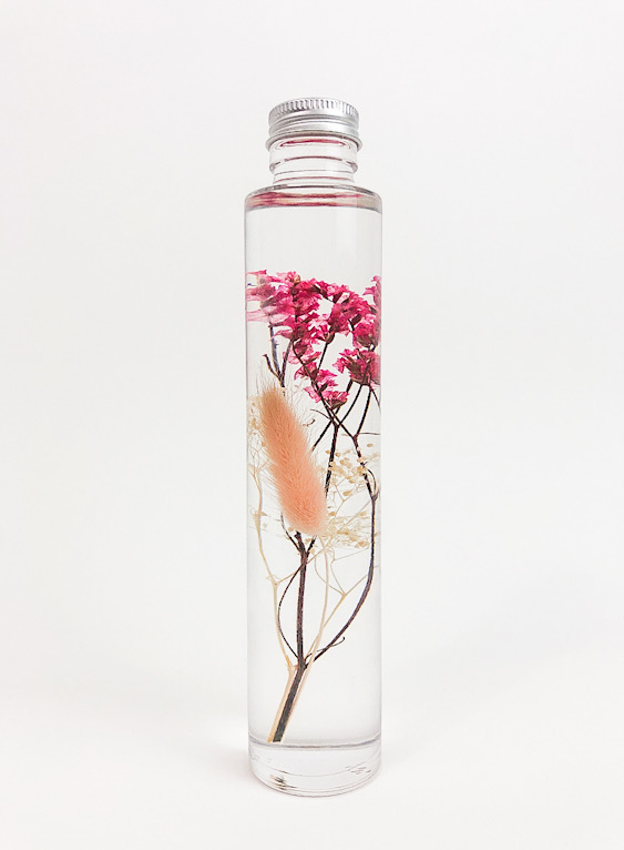 Flowers preserved in glass bottle.