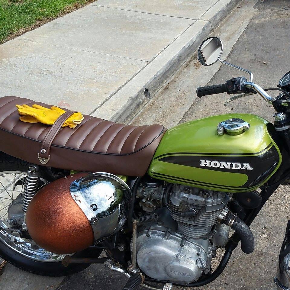 Green Honda motorcycle with gloves.