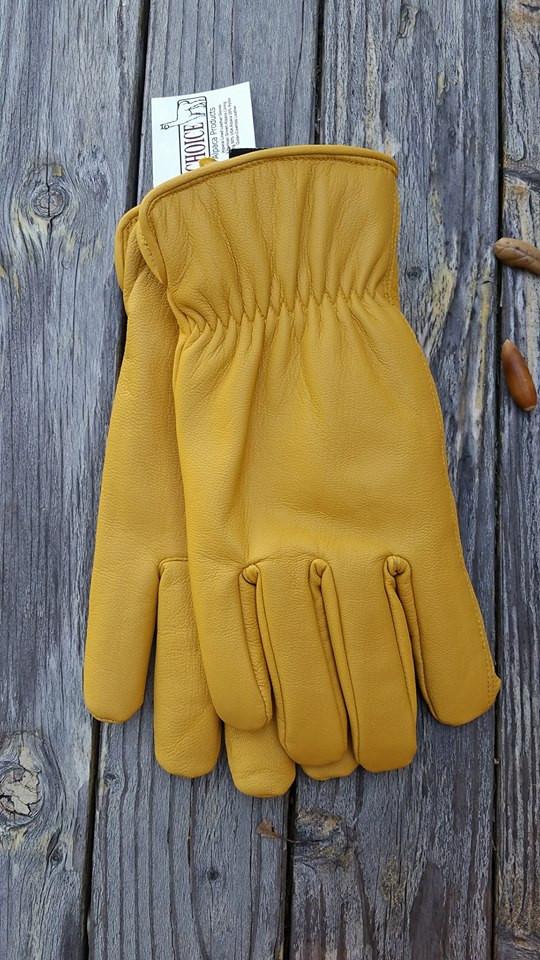 Yellow leather gloves on wood.