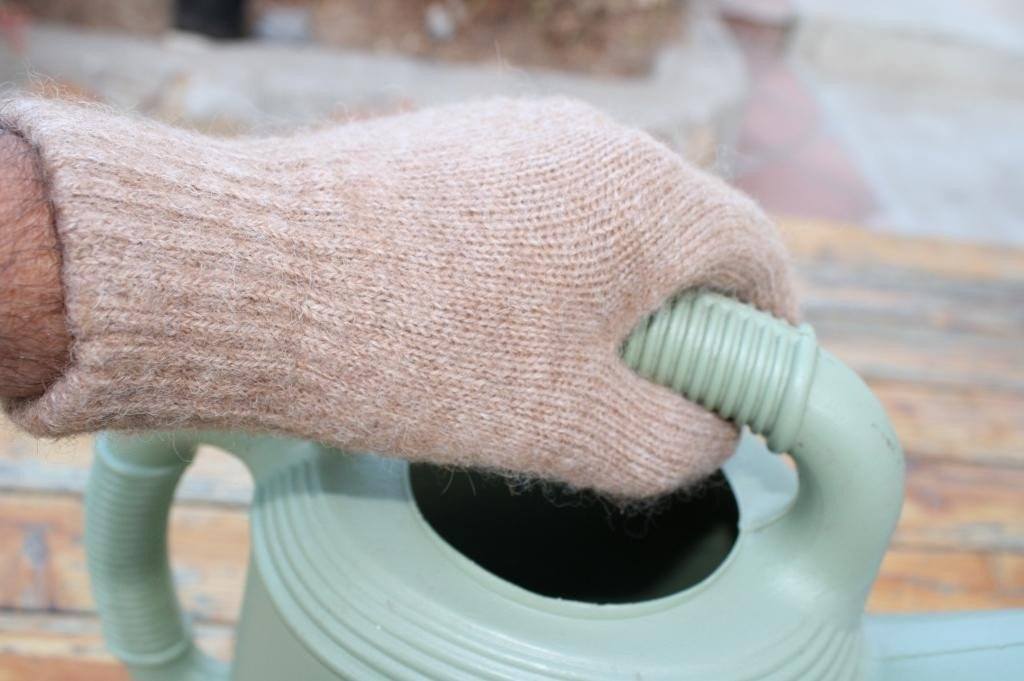 A pair of warm, soft Alpaca Work/Play Gloves in natural colors including Charcoal Grey, Carhart Brown, and Light Camel/Fawn, showcasing their cozy design.