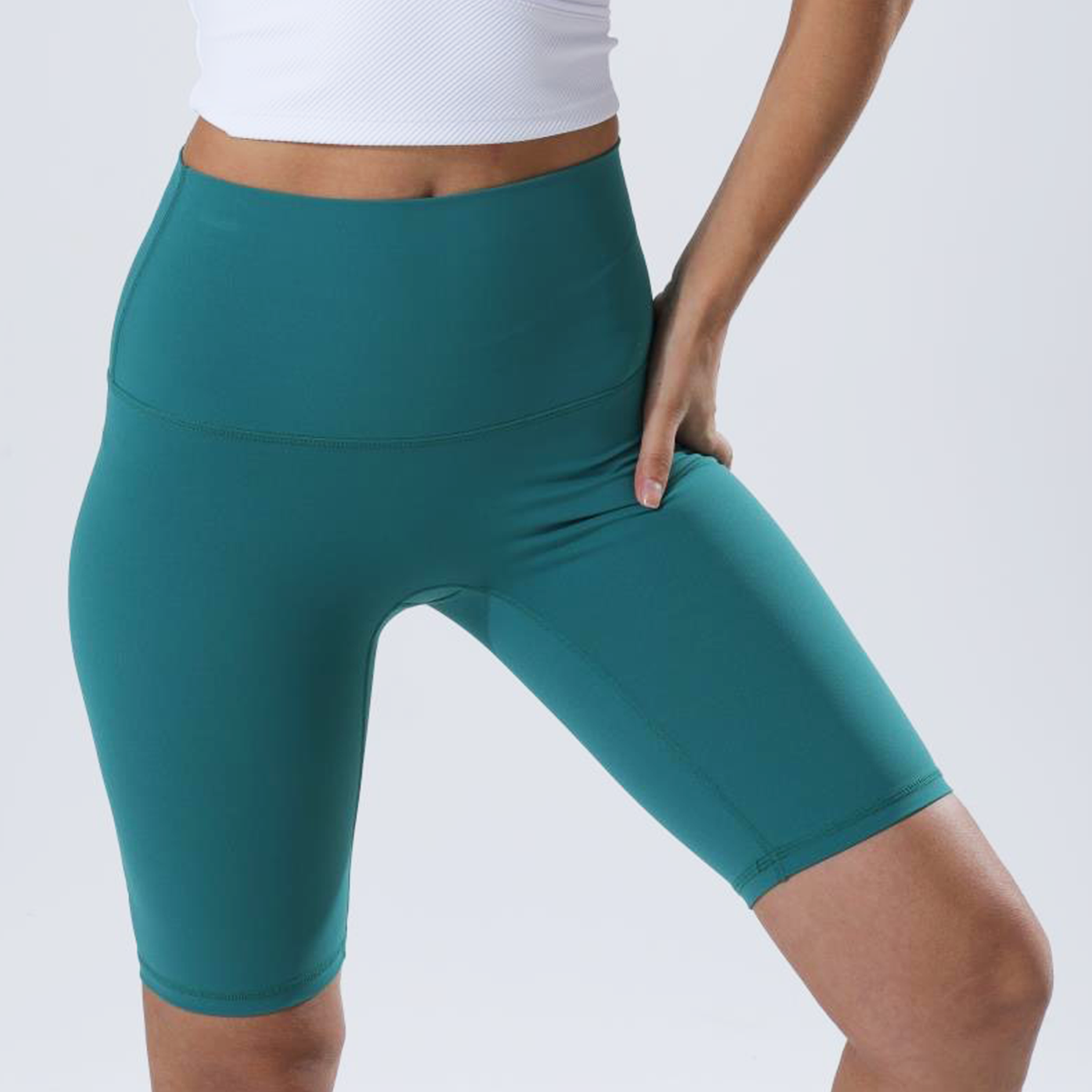 HauteD DK Bike Short in light green and deep green, featuring a long design and wide waistband for support.