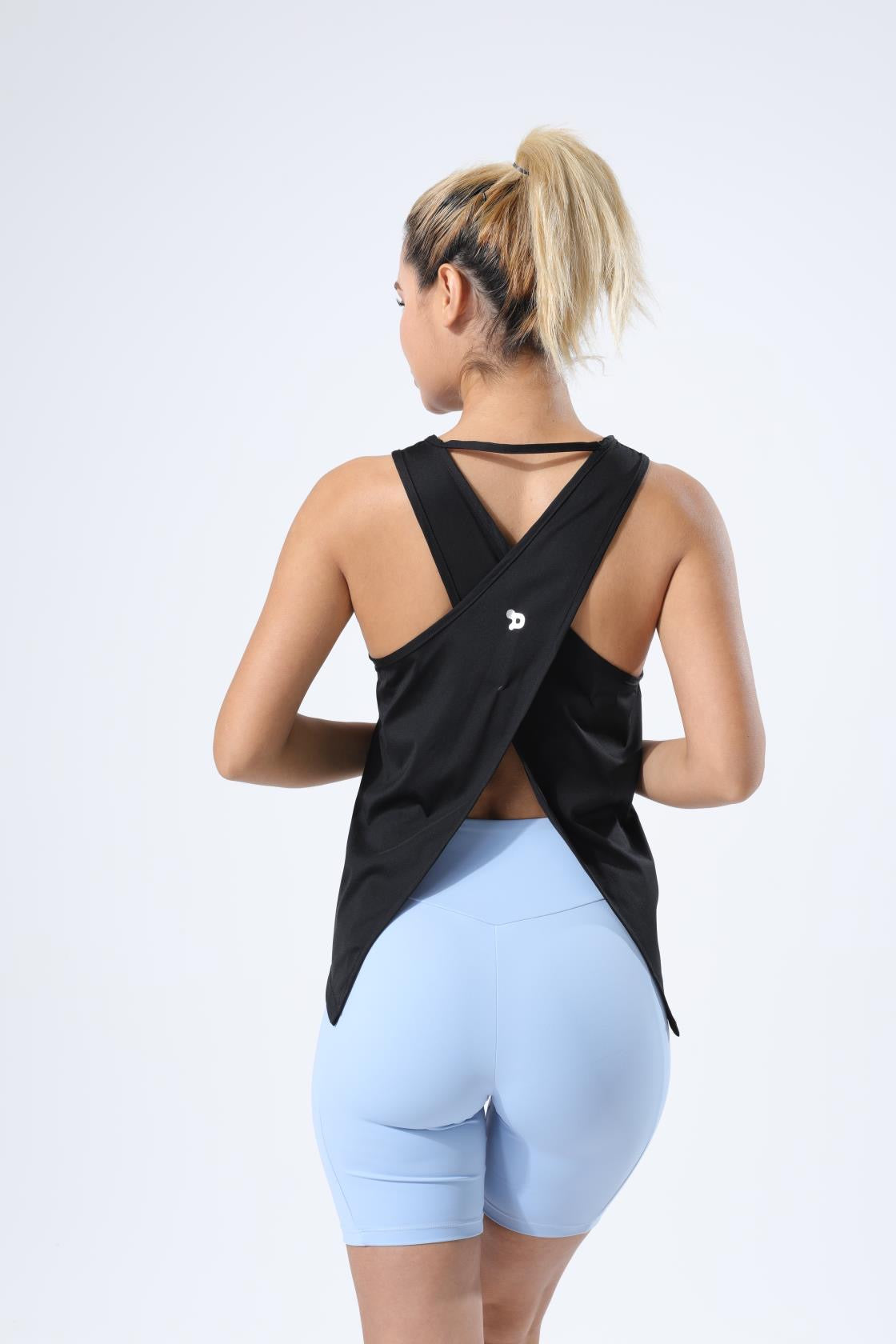 HauteD DK Cross Back Tank Top in a stylish design, showcasing its lightweight fabric and cross-back feature, perfect for athletic activities.