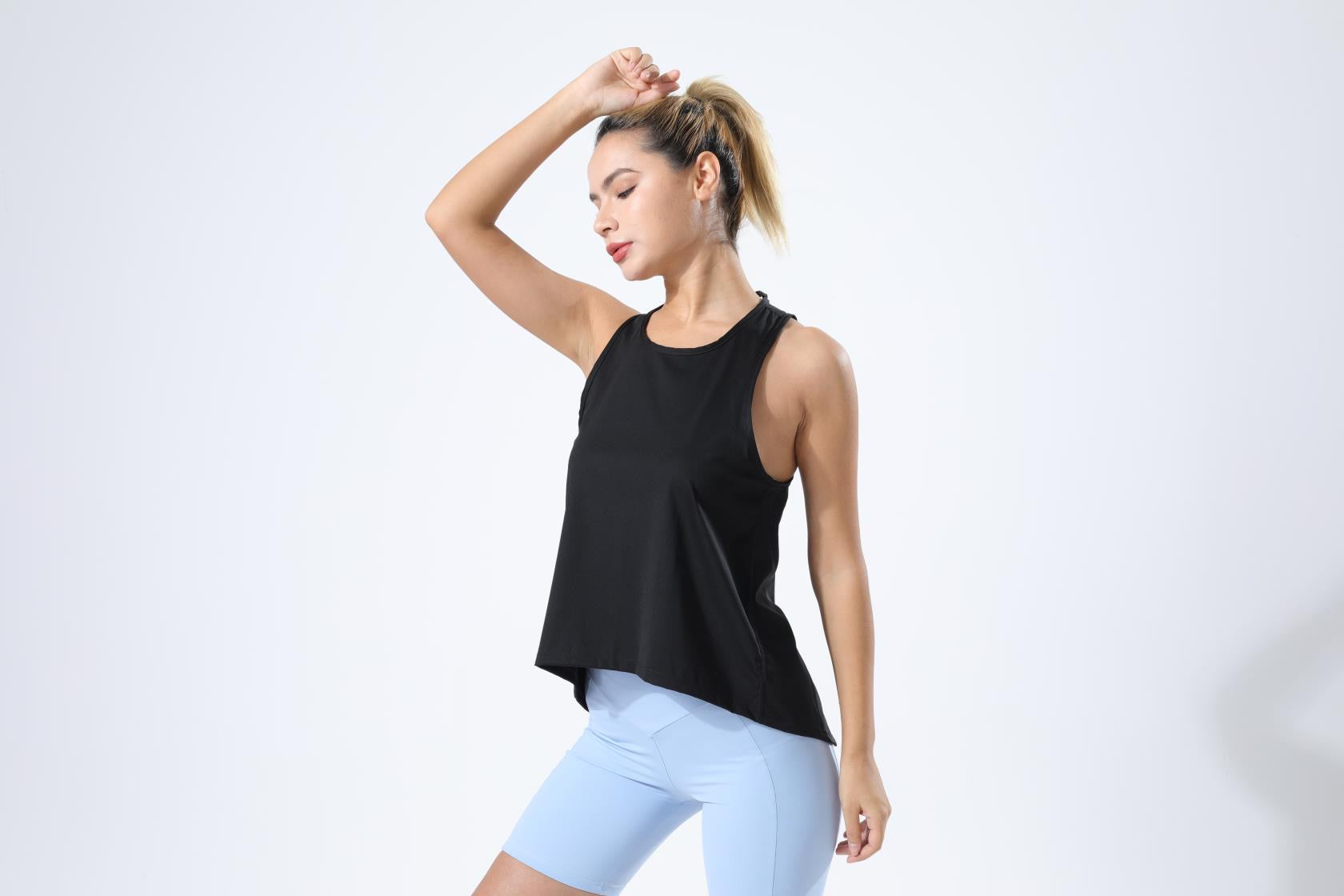 HauteD DK Cross Back Tank Top in a stylish design, showcasing its lightweight fabric and cross-back feature, perfect for athletic activities.