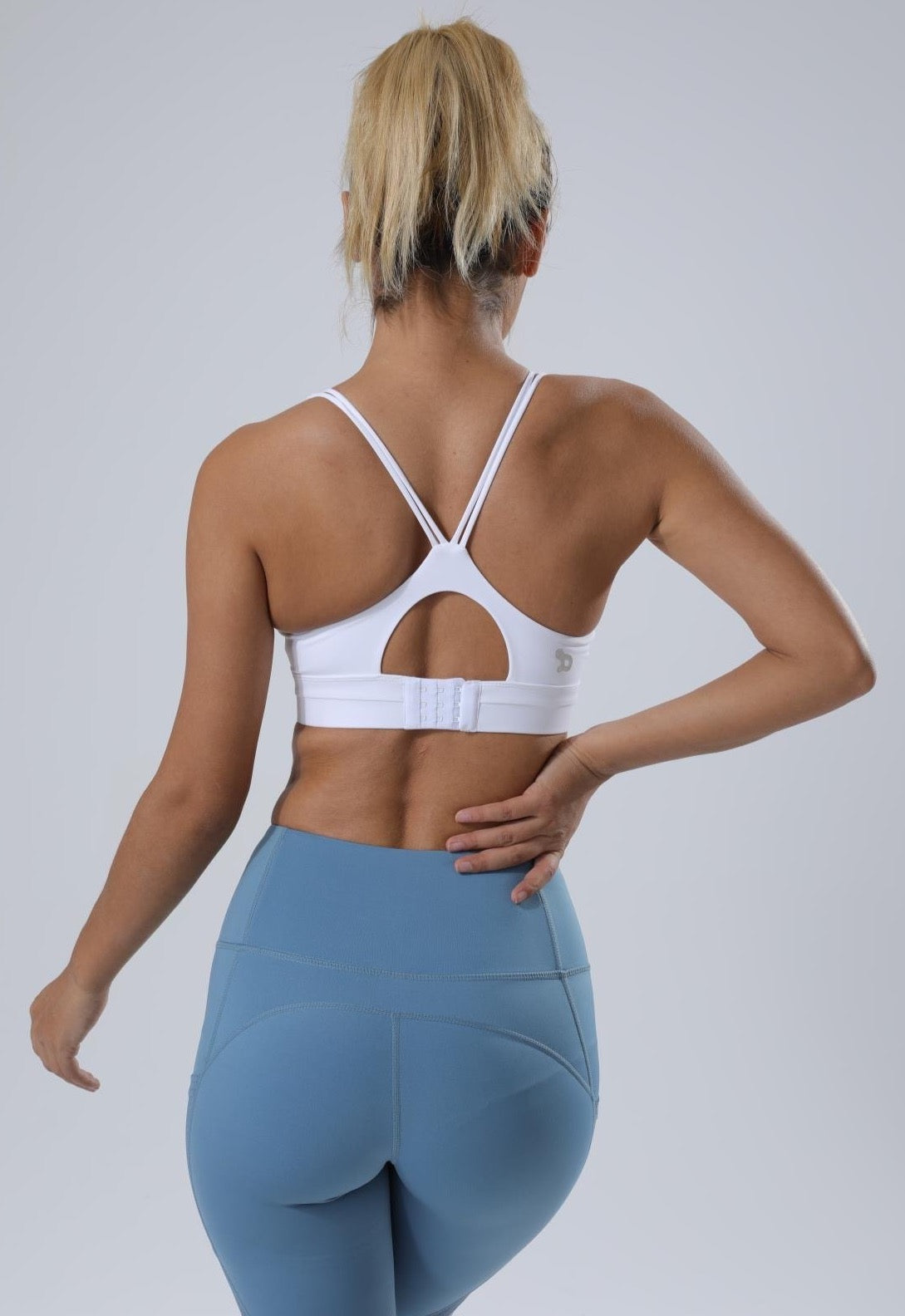 HauteD DK X Back Sports Bra featuring stylish cross back design and adjustable clasp for support during workouts.