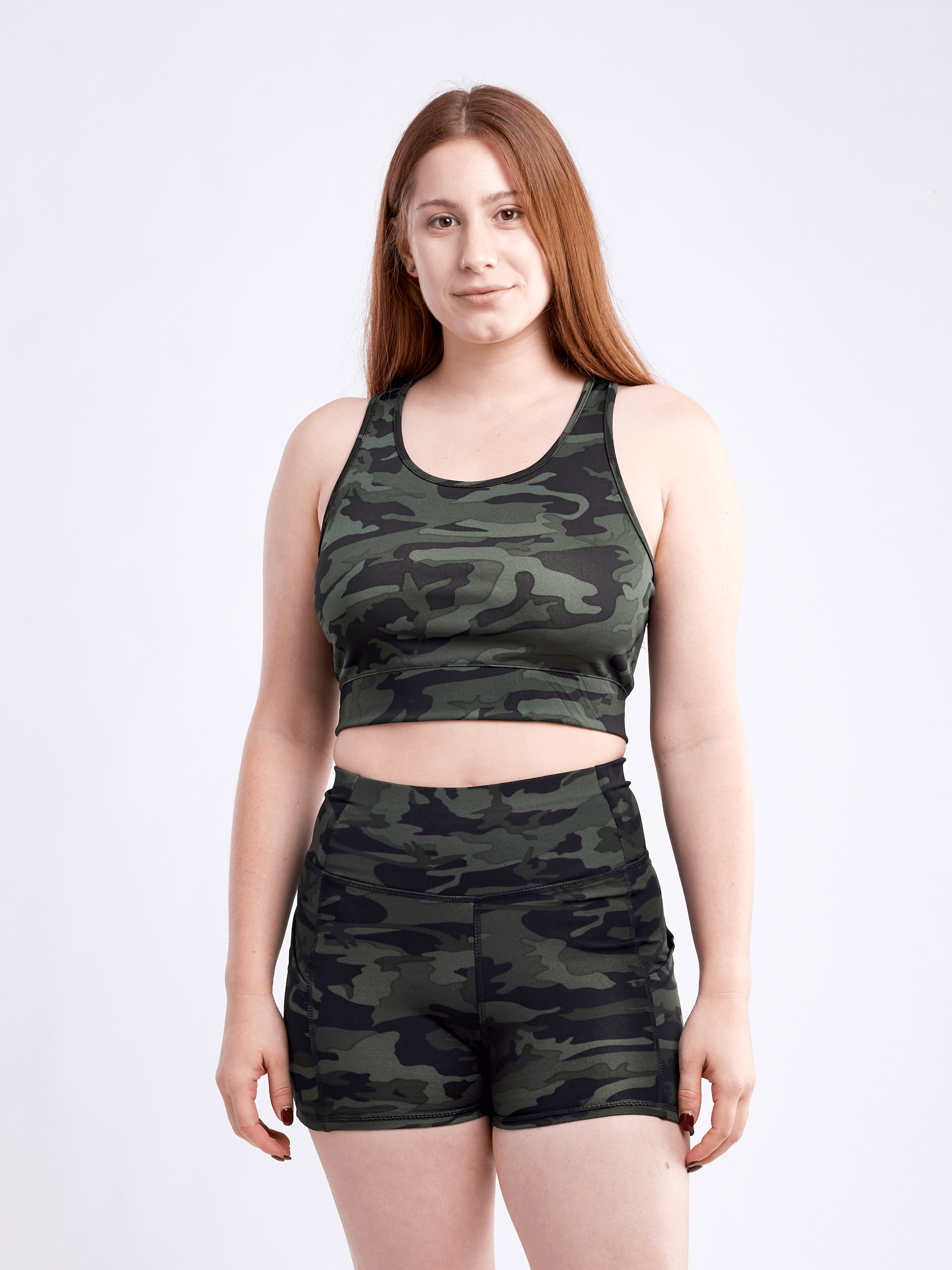 High-waisted athletic shorts for women with side pockets, made from soft polyester/spandex blend, ideal for workouts and casual wear.