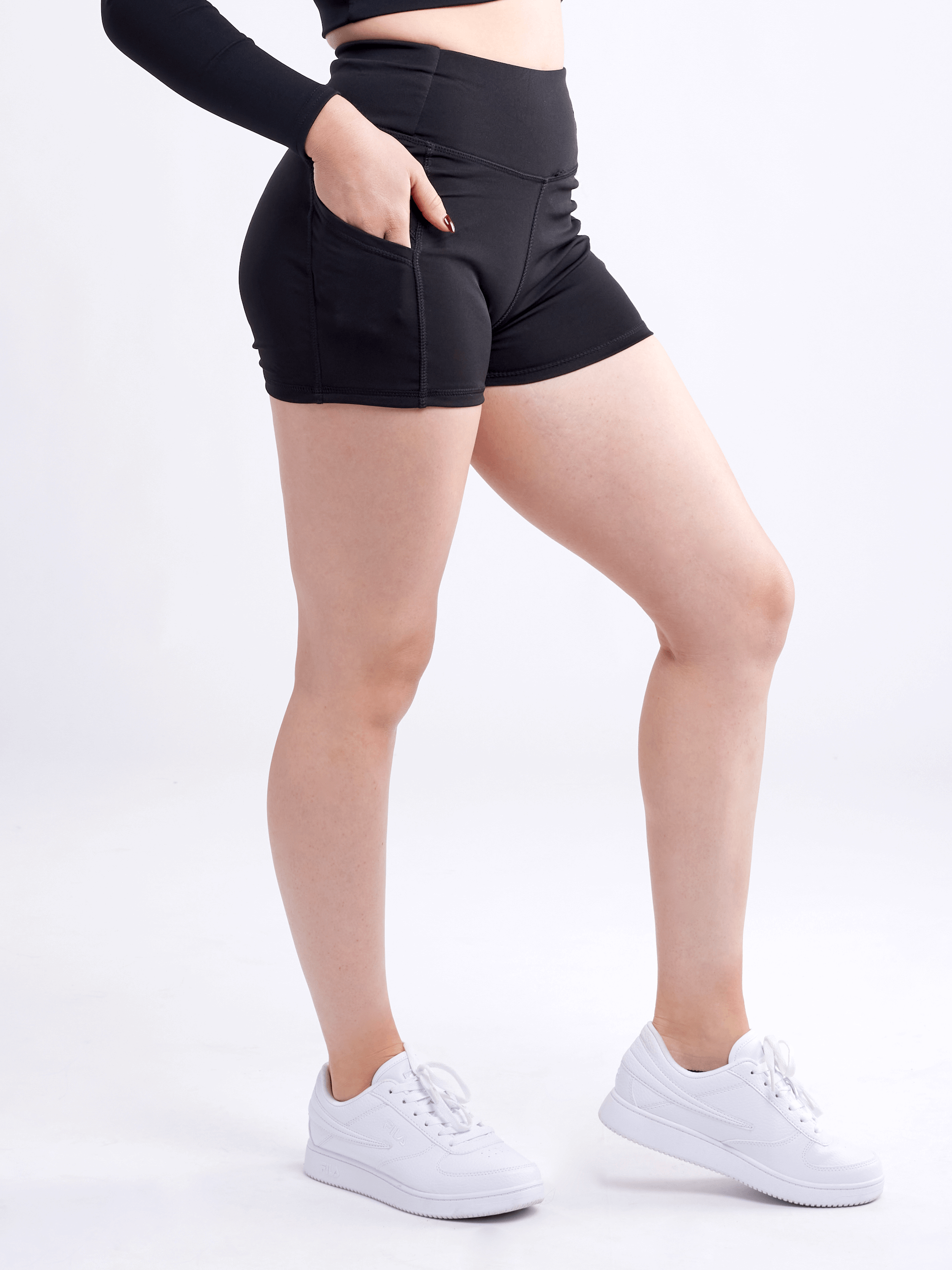 High-waisted athletic shorts for women with side pockets, made from soft polyester/spandex blend, ideal for workouts and casual wear.