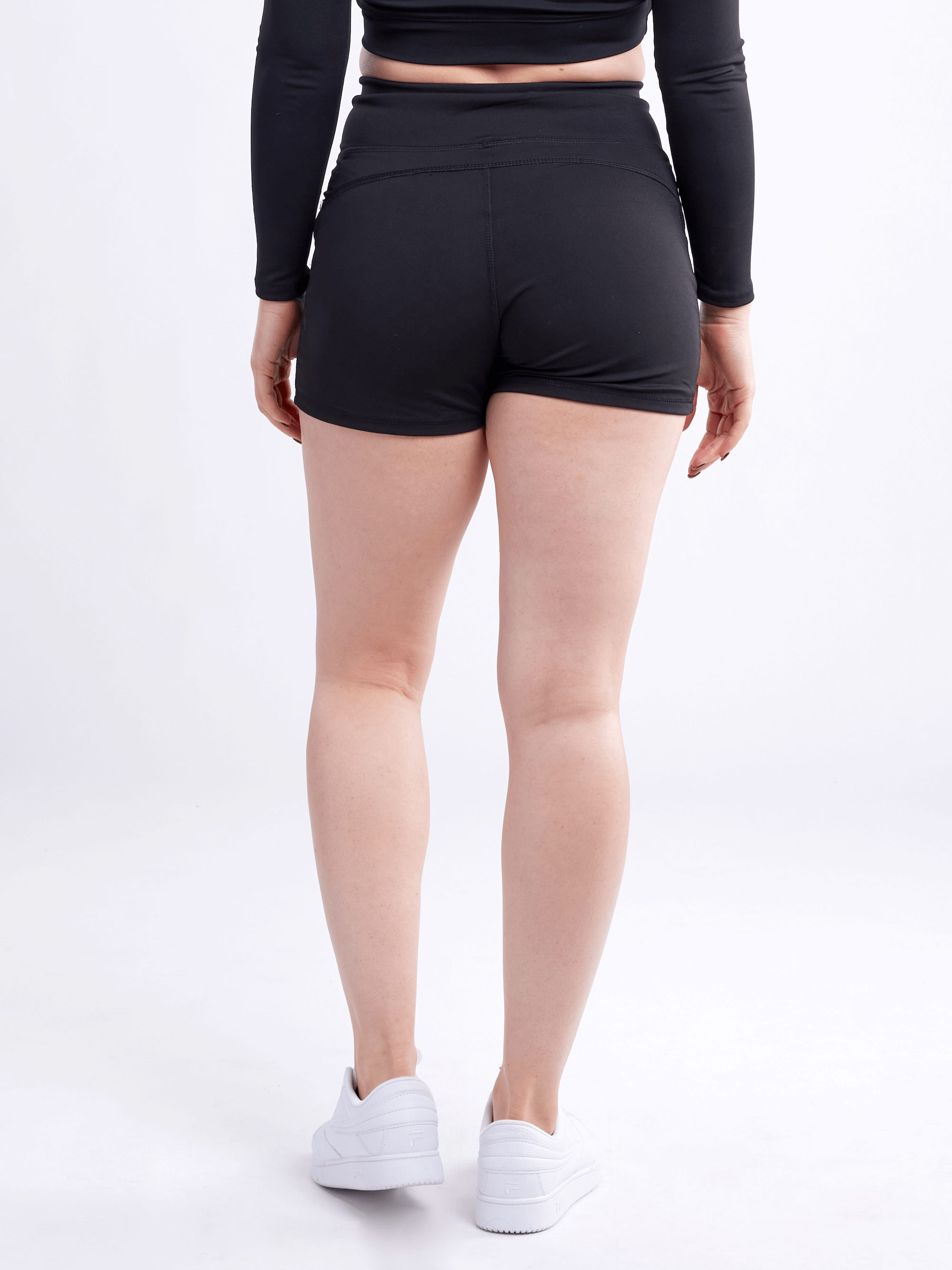 High-waisted athletic shorts for women with side pockets, made from soft polyester/spandex blend, ideal for workouts and casual wear.